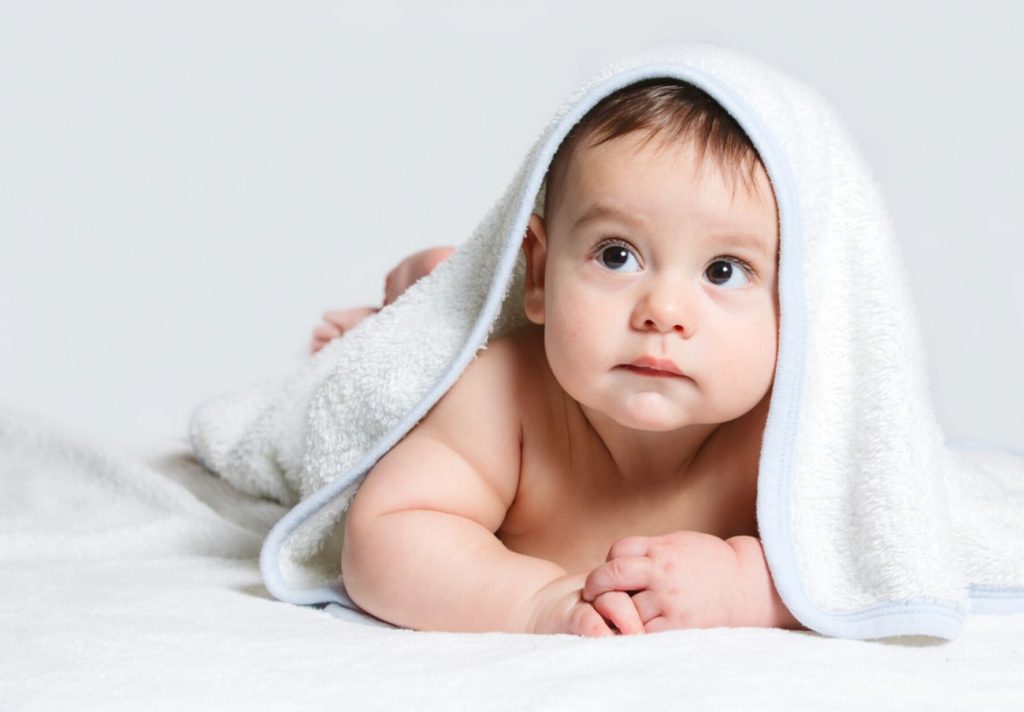 Little baby under white towel